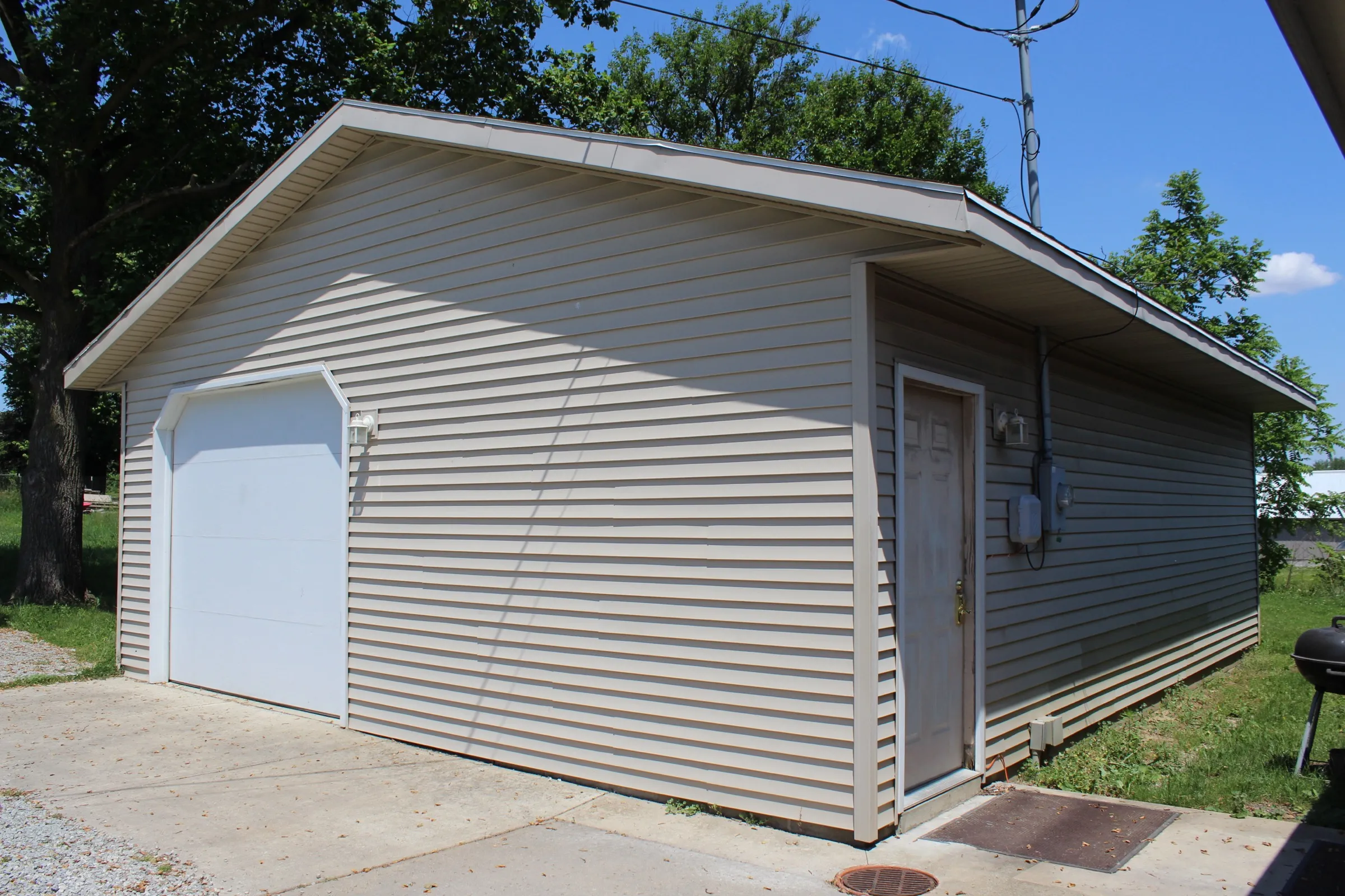 Garage seen from the side, showing the overhead door and a separate entry door on the end wall